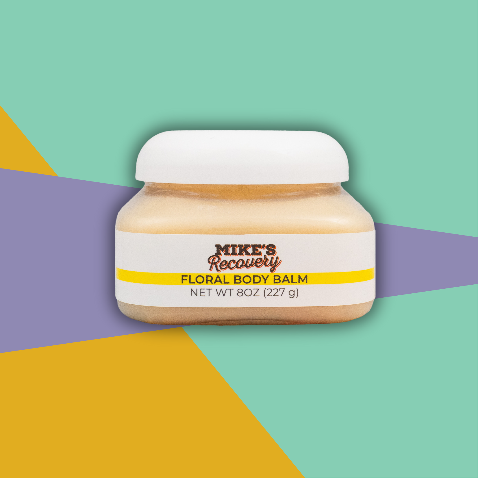 Small tub of Mike's Recovery Floral Body Balm with abstract background