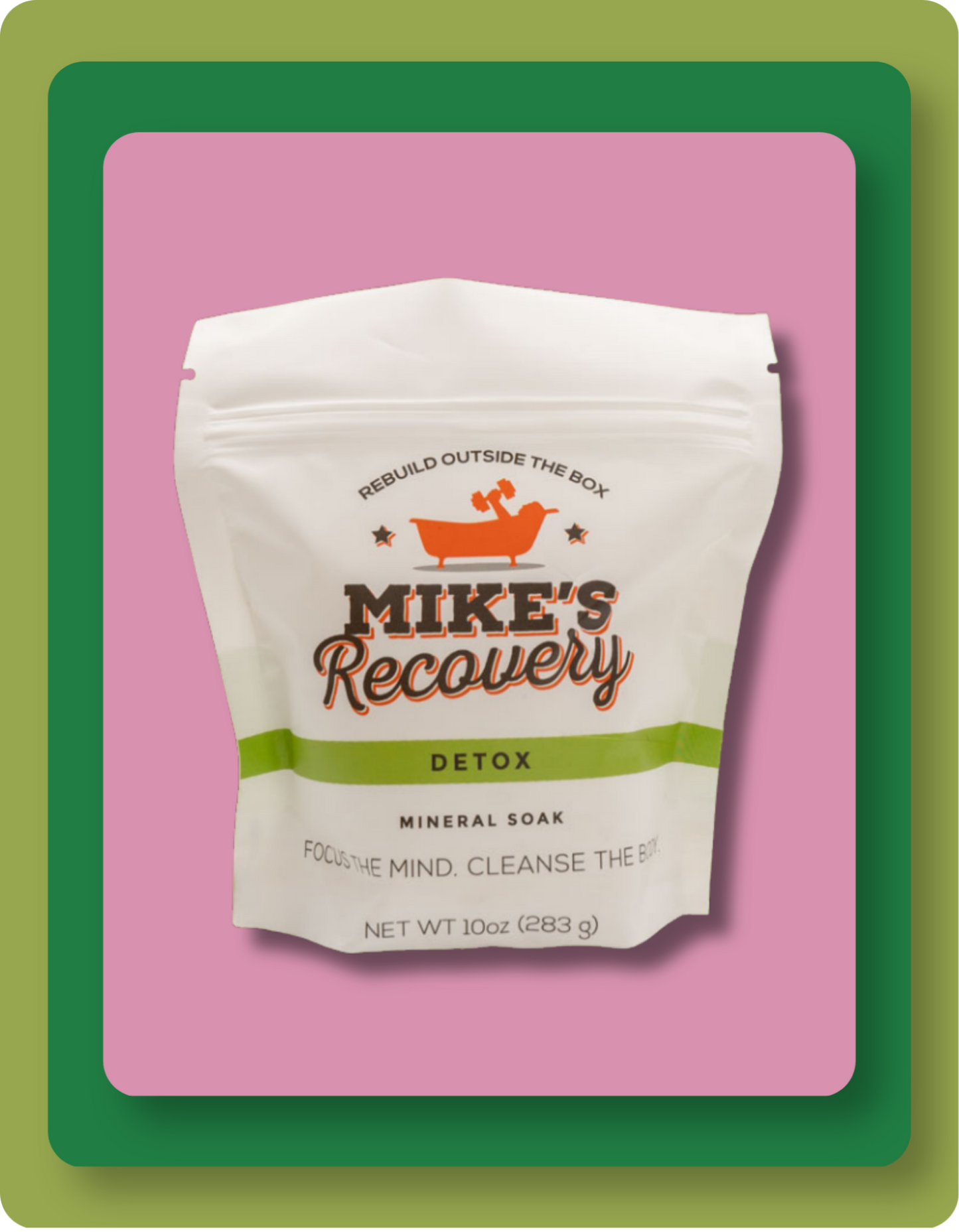 A stand-up pouch of Mike's Recovery Detox Mineral Soak, featuring a white bag with orange and green branding, set against a pink background with a green border.