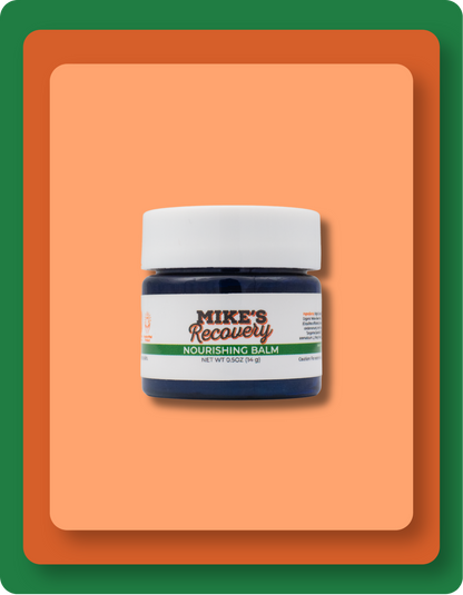 A small jar of Mike's Recovery Nourishing Balm with a white cap and a dark blue container, centered on a peach-colored rounded square with a green border.