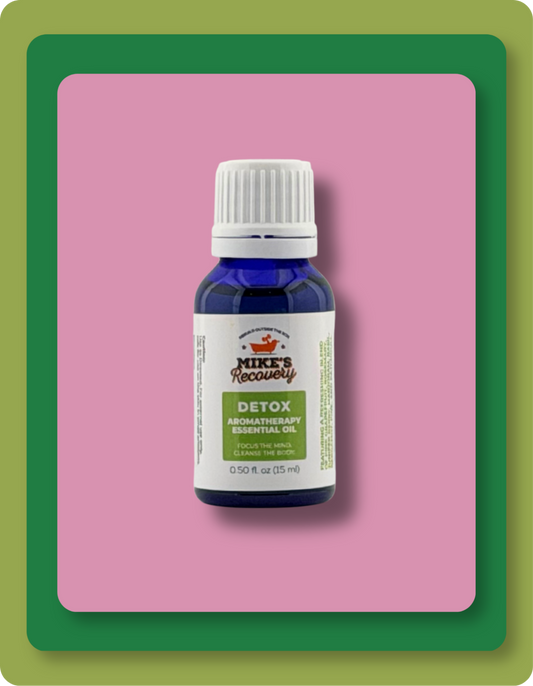A small blue bottle of Mike's Recovery Detox Aromatherapy Essential Oil with a white cap and white label, centered on a pink background with a green border.