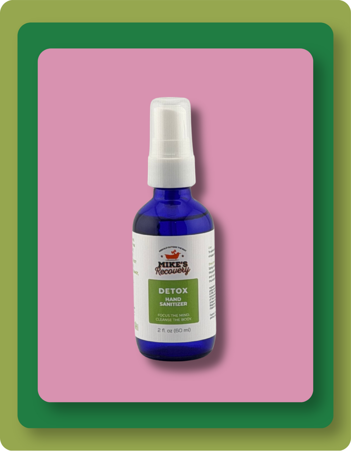A 2 fl oz cobalt blue spray bottle of Mike's Recovery Detox Hand Sanitizer with a white pump and white label, set against a pink background with green and orange border frames.