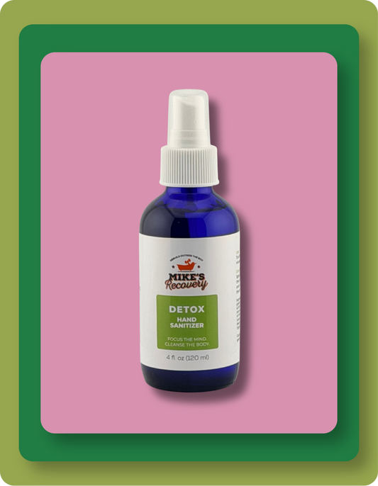 Mike's Recoverly Detox Hand Sanitizer in a 4 fl oz cobalt blue bottle with a white spray cap, set against a pink background with green and orange borders.