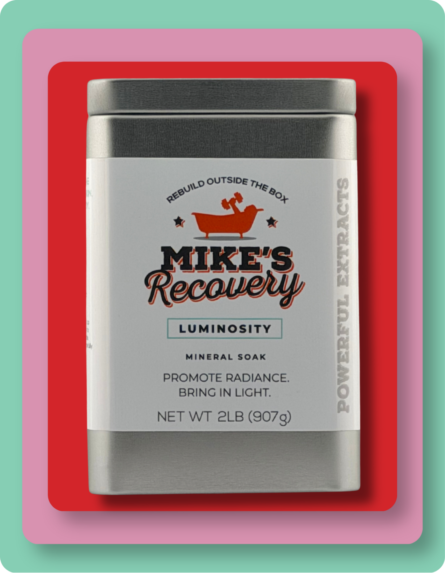 A rectangular metal tin of Mike's Recovery Luminosity Mineral Soap, featuring a white label with red and black text, set against a layered pink, red, and mint green background.