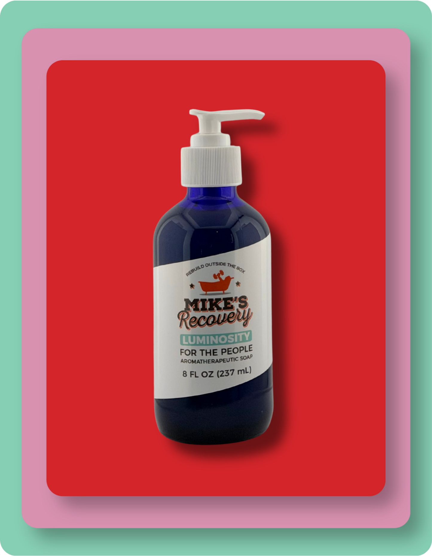 A dark blue pump bottle of Mike's Recovery Luminosity hand and body soap set against a bold red background with a pink and mint green layered border.