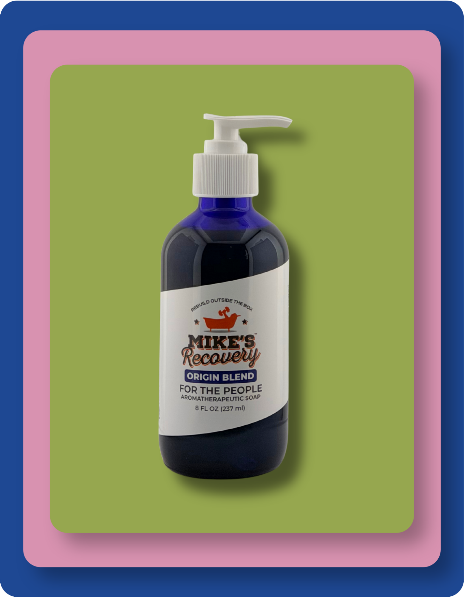 A dark blue pump bottle of Mike's Recovery Origin Blend Natural Soap centered on a green background with pink and blue border frames.