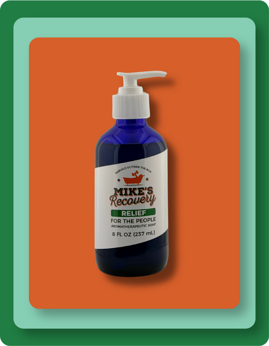 A blue pump bottle of Mike's Recovery Relief Aromatherapy Soap centered on an orange background with layered green and teal borders.