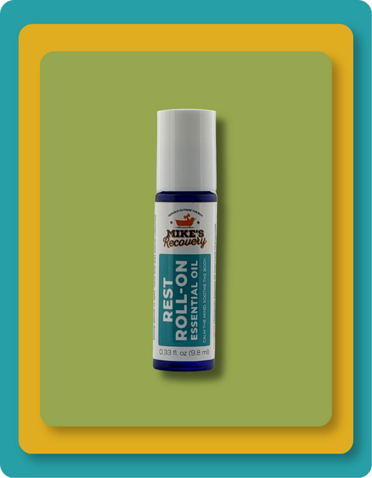A small essential oil roll-on bottle labeled Mike's Recovery Rest Roll-On Essential Oil, centered on a green rounded rectangle with a yellow-orange border.