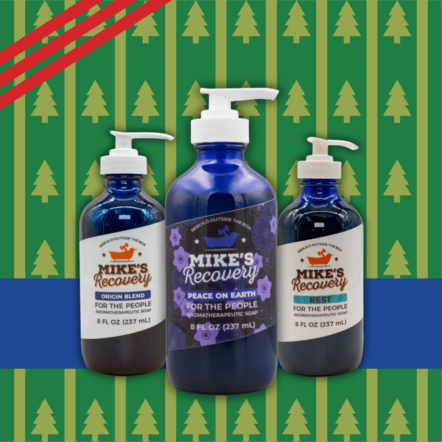 Three bottles of Mike's Recovery soap on a green and blue patterned background
