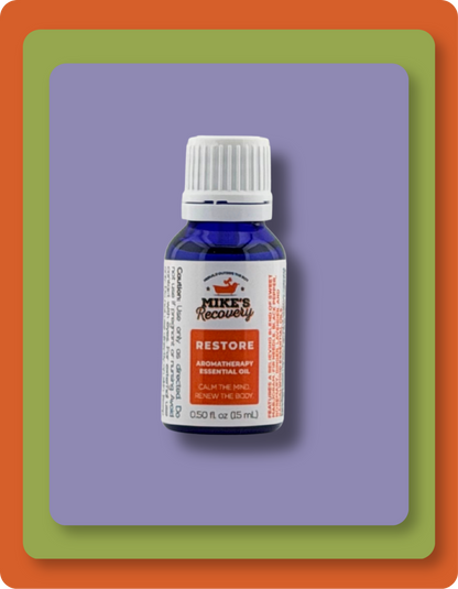 A small blue glass bottle of Mike's Recovery Restore essential oil with a white cap and white label, centered on a purple square background with green and orange border frames.